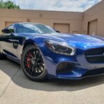 Blue sports car parked in a lot.