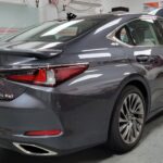 Sleek gray sedan in a garage setting.