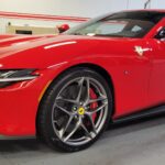 Red sports car parked in a garage.