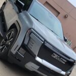 Silver GMC truck parked on concrete surface.