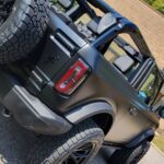 Black off-road vehicle parked, top down.