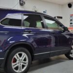 Blue SUV in a window tinting shop.