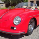 Red vintage convertible car parked outside.
