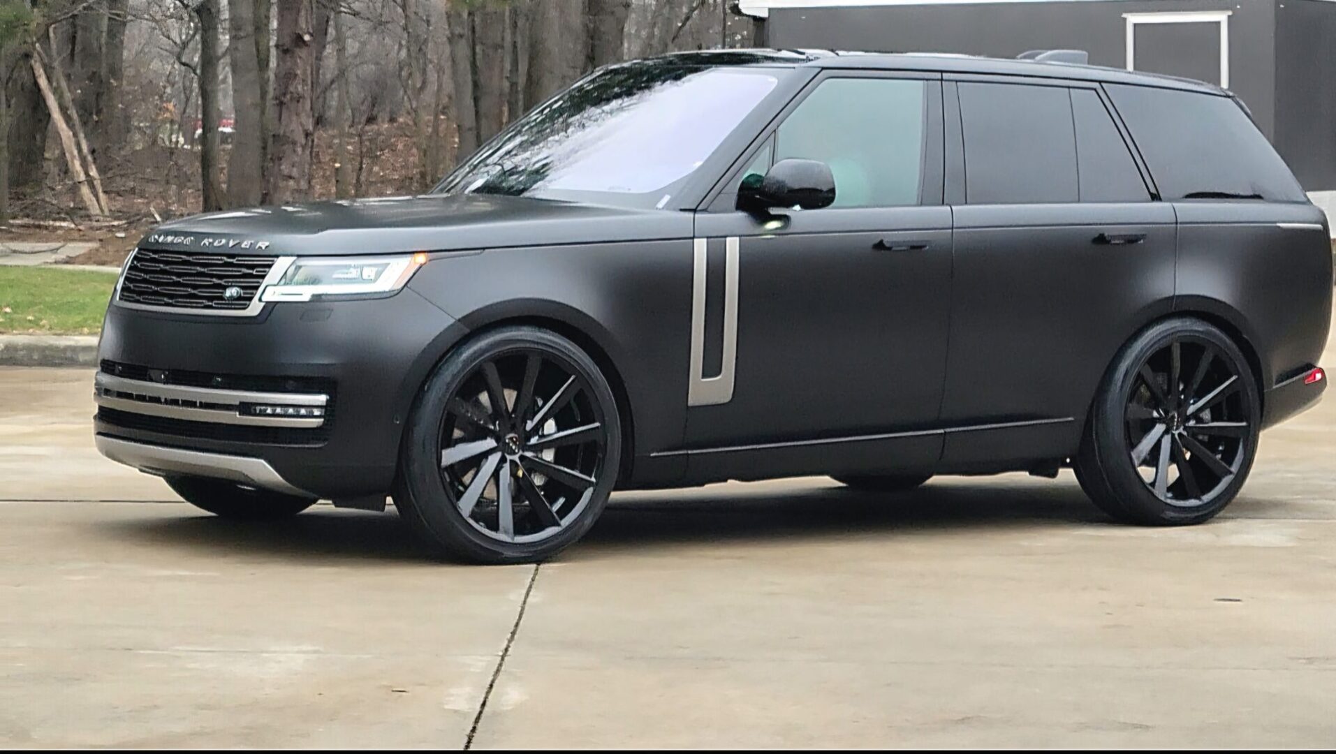 Matte black SUV parked on concrete surface.